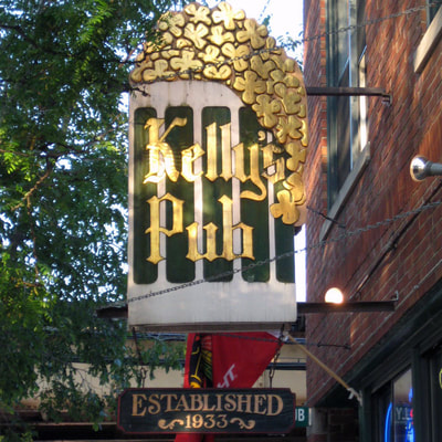 Image of Carved, sandblasted and gold leafed wooden sign for Kellys Pub Lincoln Park Chicago, IL